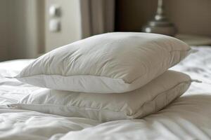 Two white pillows resting on a bed in a hotel room photo
