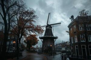 Traditional dutch windmill standing tall on a cloudy autumn day in the city photo