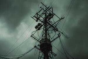 Dark and ominous utility pole looming over a stormy sky photo