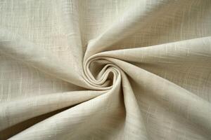 Swirled beige linen fabric texture background showing natural pattern photo