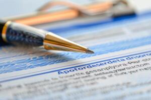 Elegant pen is lying on a swedish document about sickness benefit application photo