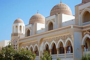 Modern islamic architecture featuring ornate details and multiple domes on a sunny day photo