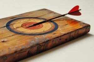 Red dart hitting the center of an old target on wood photo