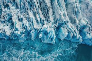 Glacier ice melting in ocean creating abstract shapes and textures photo