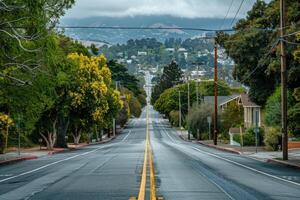 Empty street leading towards the hills on a cloudy day photo