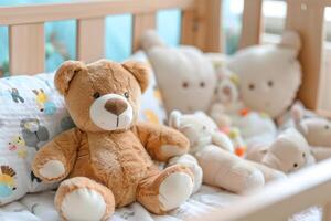 Teddy bear sitting in crib with other stuffed animals photo