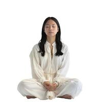 Young woman practicing meditation in white outfit on white background photo