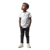 Young boy with hands in pockets looking up with curious expression photo