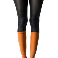 Woman wearing orange socks and black leggings standing on white background photo