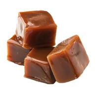 Pile of caramel candy cubes stacked on white background photo