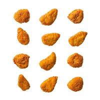 Set of delicious crispy fried chicken nuggets falling against white background photo