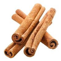 Four cinnamon sticks forming an abstract cross shape on white background photo