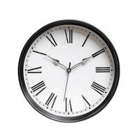 Classic clock face with black frame showing eleven o'clock on white background photo