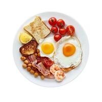 Full english breakfast with beans, bacon, and shrimp on white plate photo