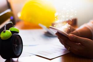 Hands of businesswoman using mobile phone and sending mail on working desk in office. photo