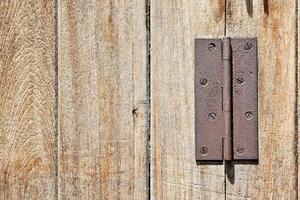 Rusty Old Hinge on Wooden Background. photo