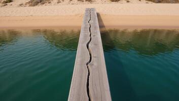 Abstract river scene water and natural elements depicted on an old wooden slab with a darkturquoise epoxy finish viewed from above over a sandy beach and riverbanks drone perspective photo