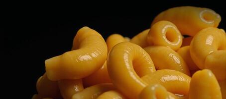 Isolated macro shot Cooked macaroni for mac cheese on a black backdrop photo