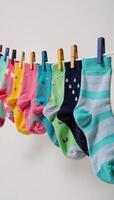 Colorful socks adorned with intricate designs hanging to dry on a line photo