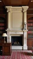An opulent room showcasing a grand fireplace and a spacious library with a study table photo