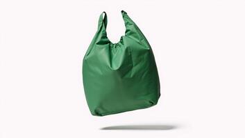Isolated green nylon bag flying against white background clipping path photo