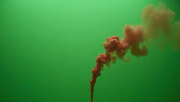 Slowmotion realistic depiction of green fog with rising red fumes in an atmospheric environment photo