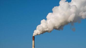 Factory emissions release smoky plumes into the atmosphere emphasizing air pollutions negative impacts on the environment photo
