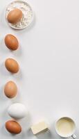 Topdown view Baking essentials eggs flour milk cottage cheese arranged against a textured white backdrop with ample room for copy photo