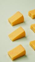 Deliciously arranged slice of cheese on a cool background with additional cheesy goodness on the table photo