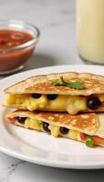 Scrambled egg black bean breakfast quesadilla with sauted bell peppers and melted pepper jack cheese photo