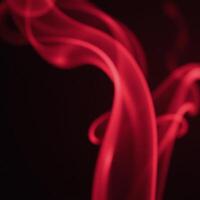 A realistic depiction of slowmoving rising red smoke and fog with an atmospheric effect photo