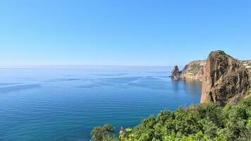 Aerial view on calm azure sea and volcanic rocky shores. Small waves on water surface in motion blur. Nature summer ocean sea beach background. Nobody. Holiday, vacation and travel concept photo