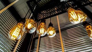 A bunch of light bulbs hanging from the ceiling photo