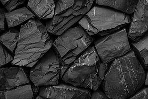 Black slate stone texture background showing rough surface with cracks forming abstract pattern photo