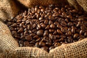 Roasted coffee beans overflowing from burlap sack photo