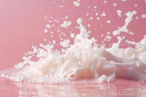 Milk splashing and creating bubbles over pink background photo