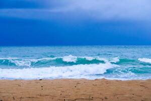 Serene Beach with Gentle Waves Under a Moody Sky Captured on a Cloudy Day photo