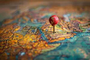 Red push pin pointing location on world map photo