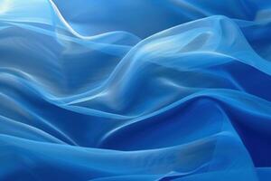 Blue transparent chiffon fabric is flowing down creating smooth elegant folds photo