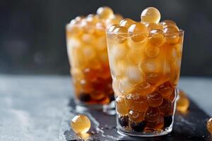 Refreshing iced bubble tea with ice cubes in glass cup photo