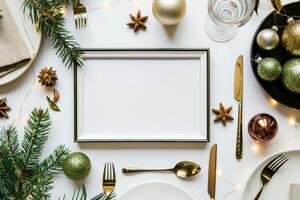 Christmas table setting with blank frame surrounded by fir branches and decorations photo