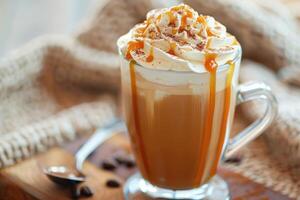 Caramel dripping down coffee latte topped with whipped cream and cinnamon photo