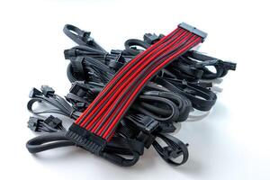 A black and red computer cable on a white background. This flexible cable features various connectors, perfect for connecting computers to peripherals and for networking tasks. photo
