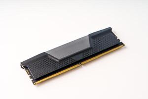 A black and gray computer memory module isolated on a white background. This DDR4 memory module features a textured surface and a metal heat spreader, widely used in modern computers. photo