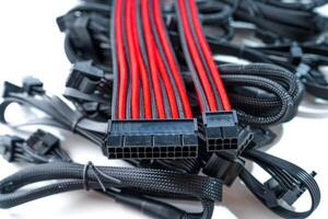 This image features a high-quality black and red computer cable isolated on a clean white background. Perfect for technology, electronic devices, and computer hardware advertising and marketing purposes. photo
