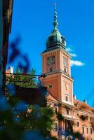 The clock tower stands proudly in the city center, surrounded by greenery and bustling streets. Locals and tourists gather to capture memories and admire the beautiful architecture that reflects history. photo