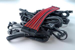 A black and red computer cable is isolated on a white background. This durable cable ensures efficient connections between computers and power sources, providing reliable performance for various devices. photo