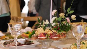 Guests wait to be invited to a buffet table with appetizers and an assortment of dishes in slow motion. video
