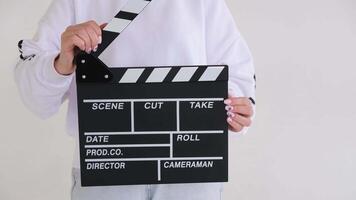 Filmmaker clapping a movie slate in slow motion against a clean white background captures the essence of filmmaking video