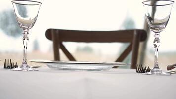 Empty wine glass is placed on a wedding table, captured in slow motion, adding elegance to the celebration setting video